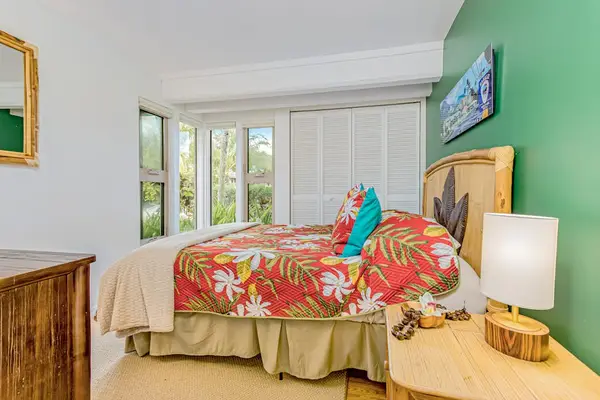 Guest bedroom with queen bed and flat screen tv.