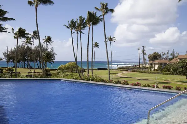 Relax poolside surrounded by tropical landscaping