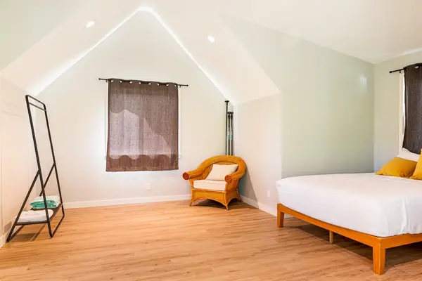 Spacious Queen Guest Suite with Cozy Seating Nook & Clothing Rack