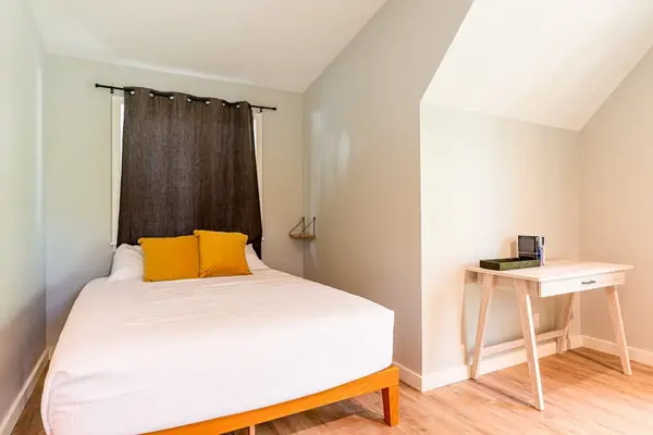 Queen Guest Suite featuring Dedicated Workspace Desk & Vaulted Ceiling