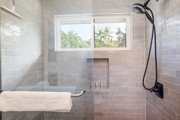 Spacious Walk-In Shower with Modern Fixtures & Tilework