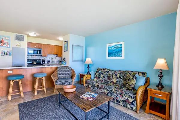 Bright tropical condo living room with sofa bed