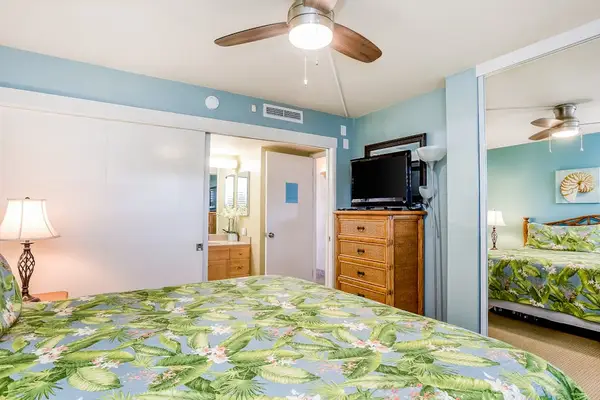 Master bedroom with king bed, ceiling fan, flat screen tv and en-suite bathroom