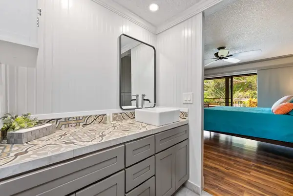 Full bathroom vanity offers generous counter space beside the bedroom