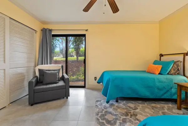 Second bedroom includes twin sleeping spaces comfortable chair and window