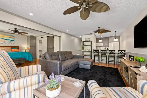 Open living area connects cozy seating with the dining space