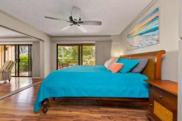 First bedroom offers turquoise bedding garden views and spacious wardrobes