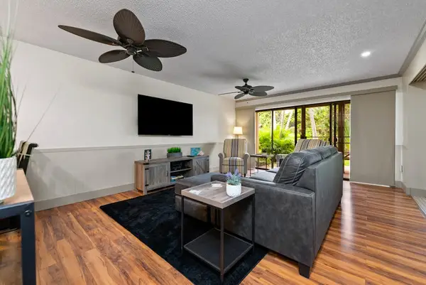 Comfortable living room features sectional sofa television and patio access