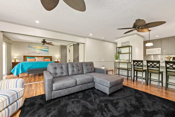 Spacious living room offers sectional seating beside the dining area