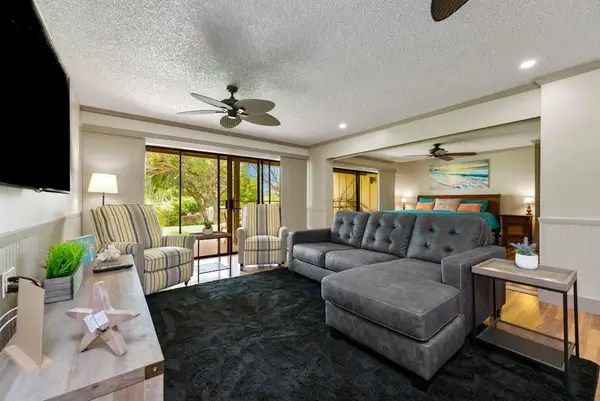 Inviting living room with sectional seating and bright garden views