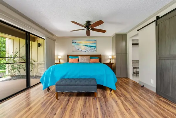 First bedroom features king bed sliding doors and garden access