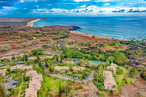 Nearby Molokai shoreline reveals turquoise ocean and rugged volcanic terrain