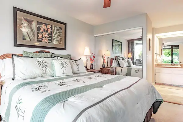 Spacious Primary Bedroom with Tropical Bedding & Mirrored Closets