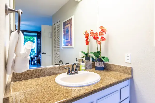 Clean Bathroom Vanity with Spacious Countertop & Mirror