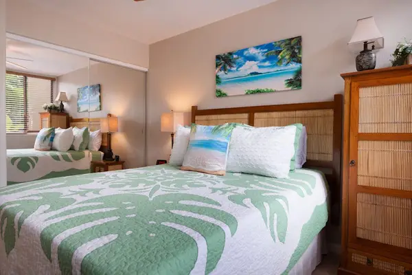 Queen Bedroom Setup with Wooden Dresser & Bedside Lamps