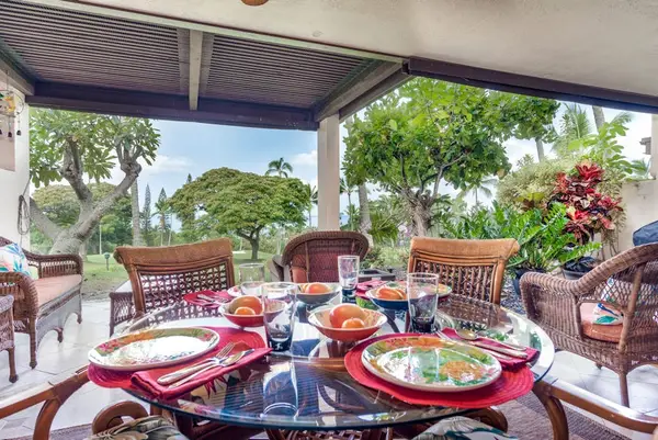 Covered Lanai Outdoor Dining Set with Garden Surroundings