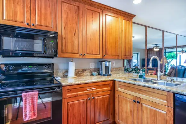 Fully Equipped Kitchen with Wood Cabinetry & Modern Appliances