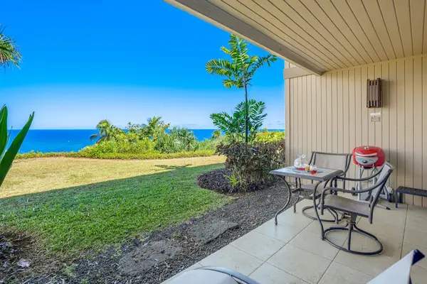 Shaded patio creates a comfortable retreat beside gardens and lawns