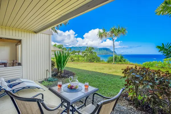 Covered patio showcases tiled flooring, bistro seating, and mountain views