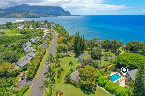 Ocean-view surroundings feature turquoise water, rugged cliffs, and tropical vegetation