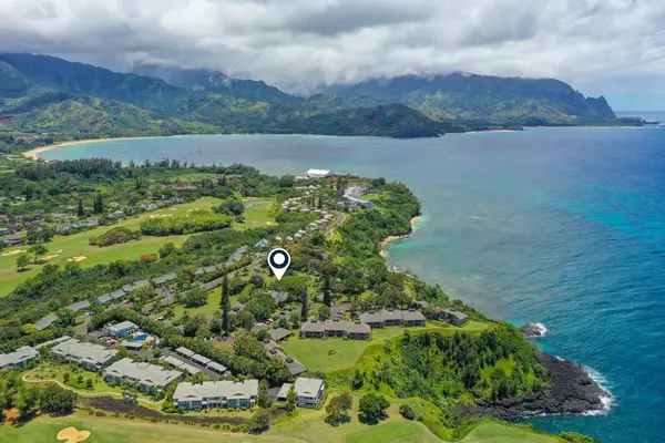 Ocean-view surroundings feature turquoise water, rugged cliffs, and tropical vegetation