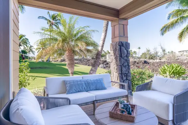 Covered Outdoor Patio with Plush Seating and Scenic Lawn Views