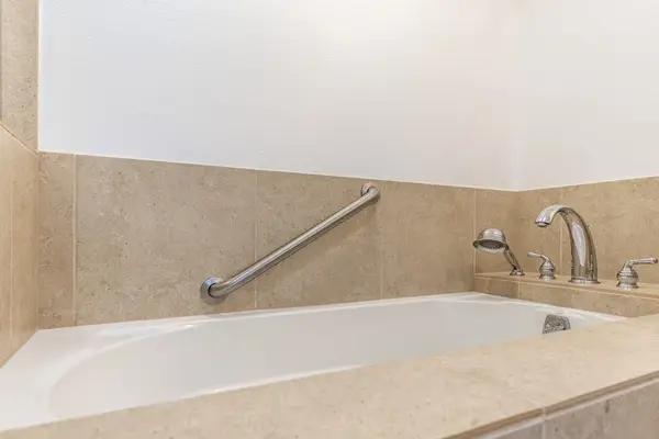 Deep Soaking Bathtub with Stainless Steel Handrail and Fixtures