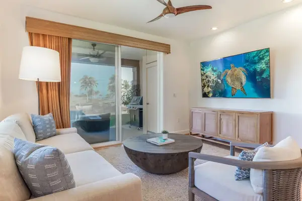 Bright Living Room featuring Wall-Mounted TV and Patio Access