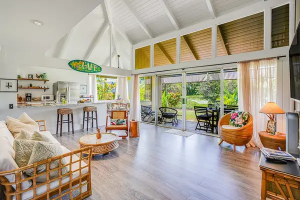 Bright open living room with tropical views