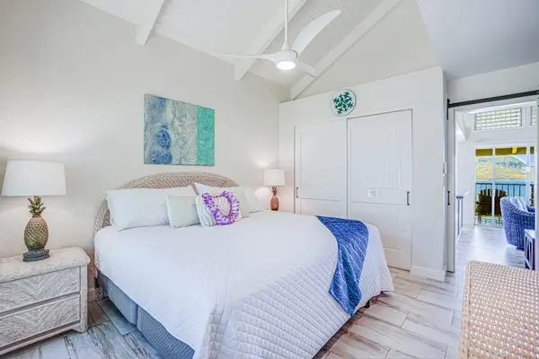Comfortable king bed in a spacious island-inspired bedroom.