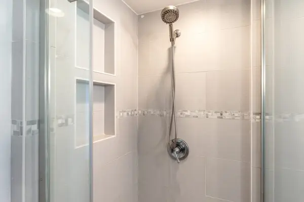 Walk-In Glass Shower with Tiled Enclosure and Wall Niche