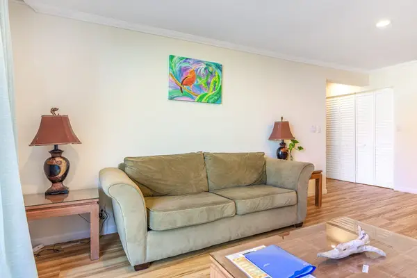 Cozy Living Room Seating Area with Comfortable Sofa, Accent Lighting, and Coffee Table