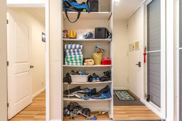 Built-In Open Closet Shelving with Towels, Bins, and Extra Storage Space