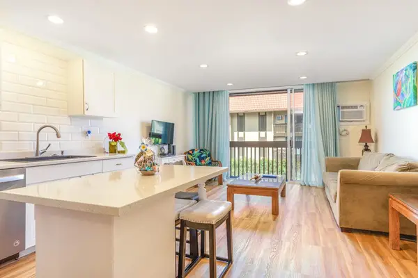 Spacious Layout Featuring Kitchen Island, Living Area, and Balcony Access