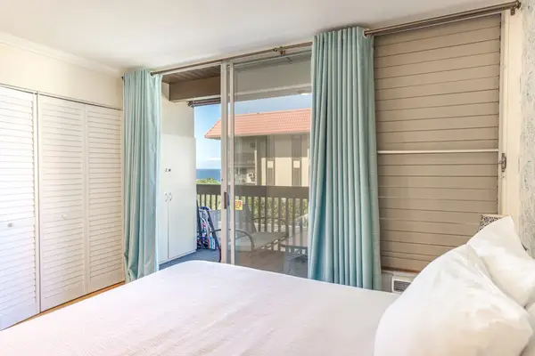 Comfortable Bedroom with Sliding Glass Doors to Private Balcony