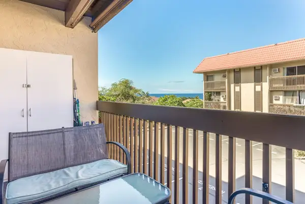 Private Balcony Patio with Outdoor Cushioned Seating and Scenic Complex Views