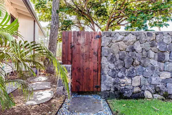 Private Gated Entrance with Custom Stone Wall & Wooden Gate