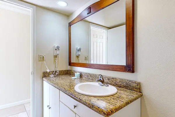 Bathroom vanity with a hair dryer and drawers for added convenience.