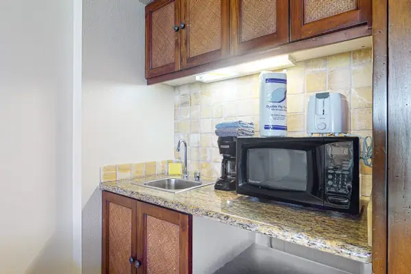 Cozy kitchenette with storage cabinets for preparing your meals.