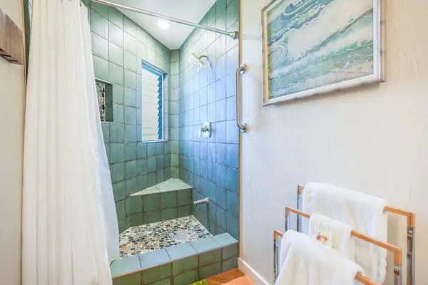 Full bathroom with a walk-in shower and fresh towels.