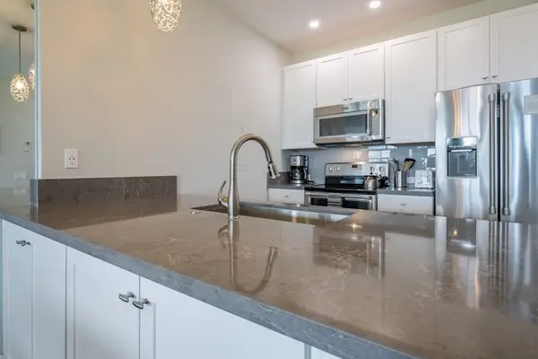 Well-equipped kitchen with sleek countertops and stainless steel appliances