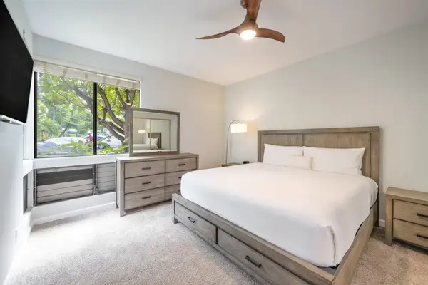 Comfortable bedroom with a TV and relaxing garden views