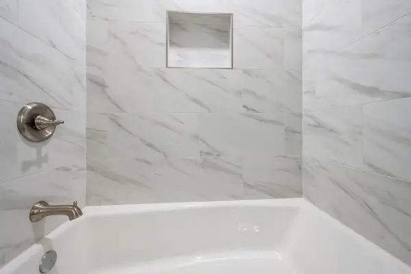 Relax in the clean and inviting tub-shower combination