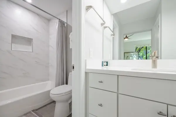Full bathroom with a bright vanity and tub-shower combination