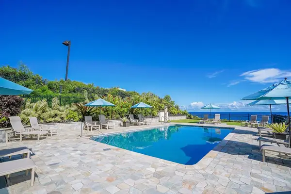 Resort-style pool surrounded by lush tropical landscaping