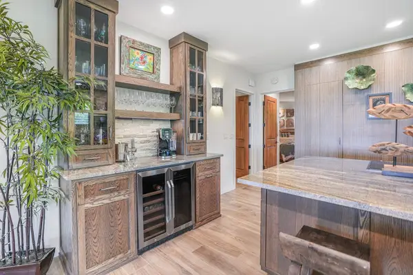 Coffee bar with a built-in wine cooler and elegant cabinetry
