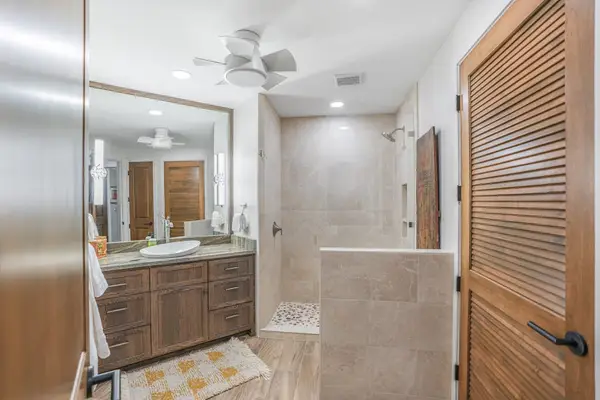 Modern guest bathroom with dual vanities and elegant finishes