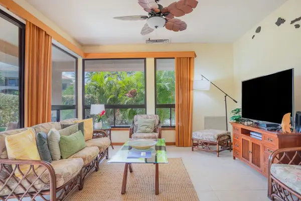 Spacious Living Room with Vaulted Ceiling & Tropical Accent Seating