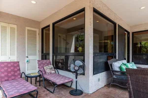 Shaded Private Lanai Corner Featuring Plush Lounge Seating & Stand Fan