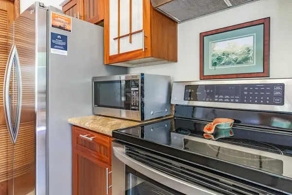 Modern Stainless Steel Appliances Set Against Custom Wood Cabinetry